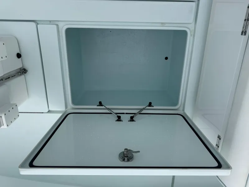 Slide: The Image of 2019 Contender 35 ST boat storage compartment with open lid, showcasing interior space. - 8