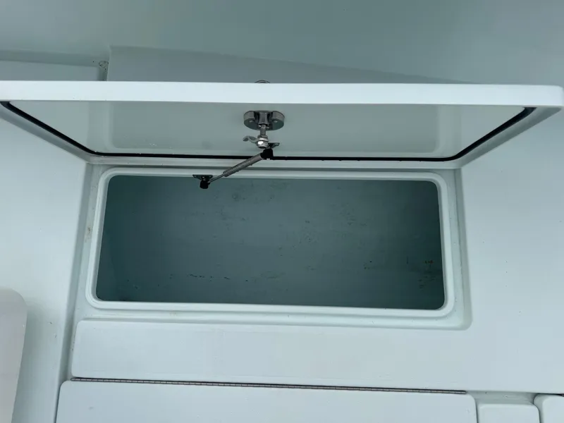 Slide: The Image of Open storage compartment on a 2019 Contender 35 ST boat. - 9