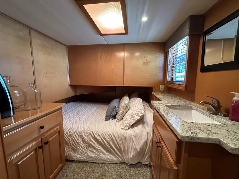 Slide: The Image of Cozy bedroom in 2008 Starlite 18x85 houseboat with wood cabinetry and granite countertop. - 10