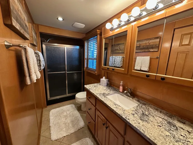 Slide: The Image of Luxurious bathroom in 2008 Starlite 18x85, featuring granite countertop and modern lighting. - 13