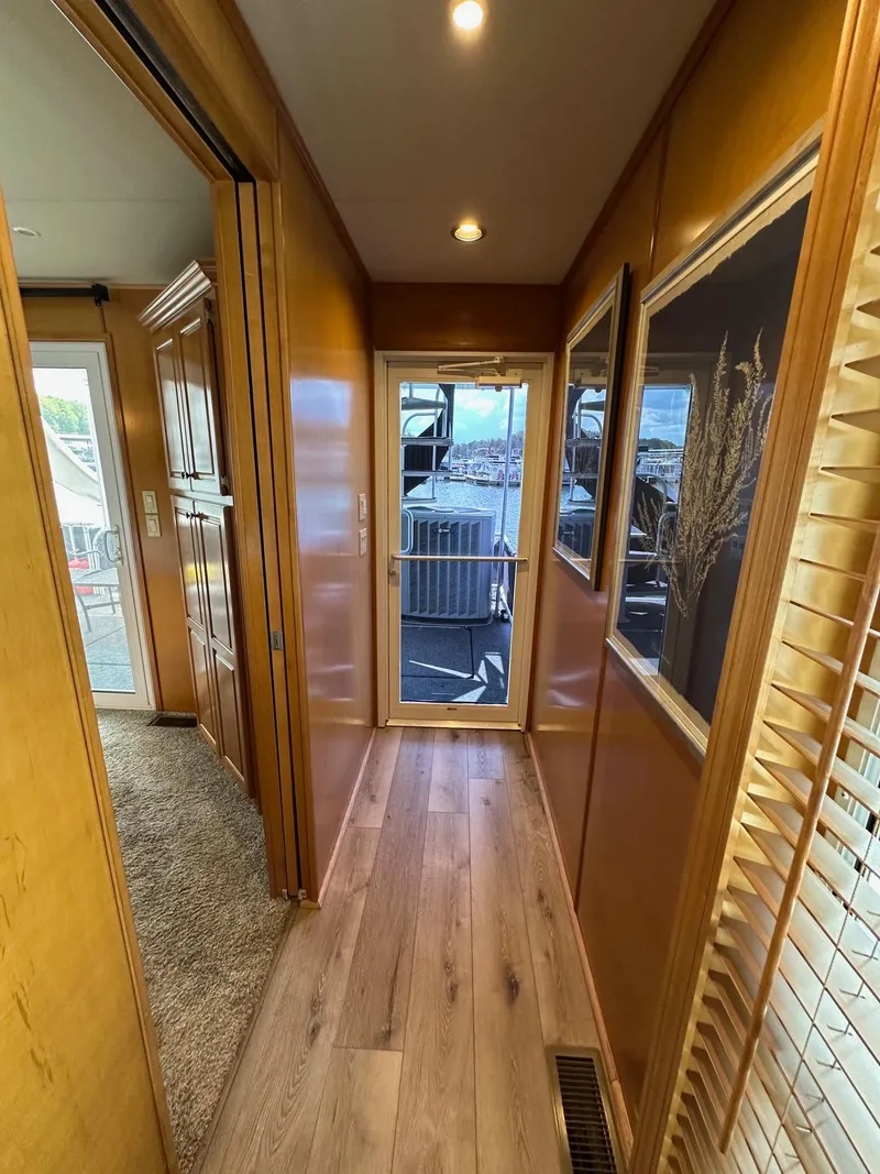 Slide: The Image of Hallway in 2008 Starlite 18x85 houseboat with wooden flooring and large windows. - 14