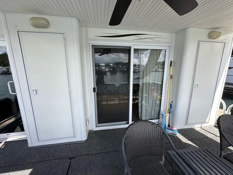 Slide: The Image of Starlite 18x85 houseboat deck with sliding doors and outdoor seating, 2008 model. - 15
