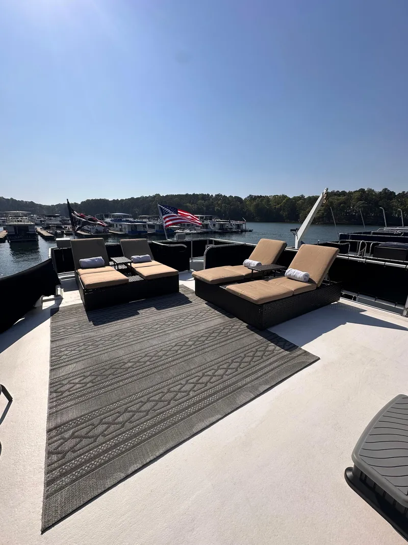 Slide: The Image of Spacious deck of 2008 Starlite 18x85 houseboat with sun loungers and scenic marina view. - 17