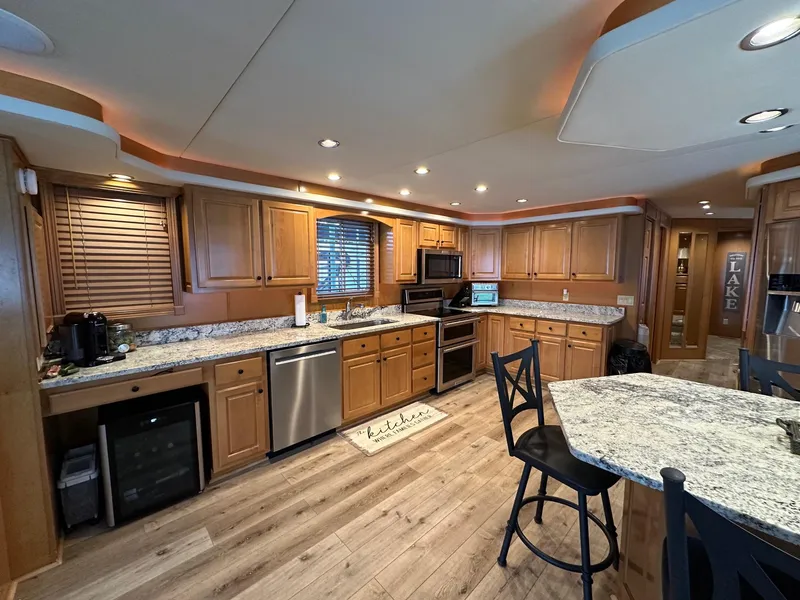 Slide: The Image of Spacious kitchen in 2008 Starlite 18x85 houseboat with wooden cabinets and modern appliances. - 5
