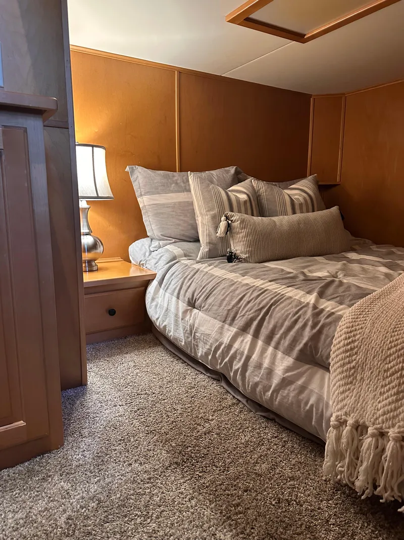 Slide: The Image of Cozy bedroom in 2008 Starlite 18x85 houseboat with plush bedding and warm lighting. - 9