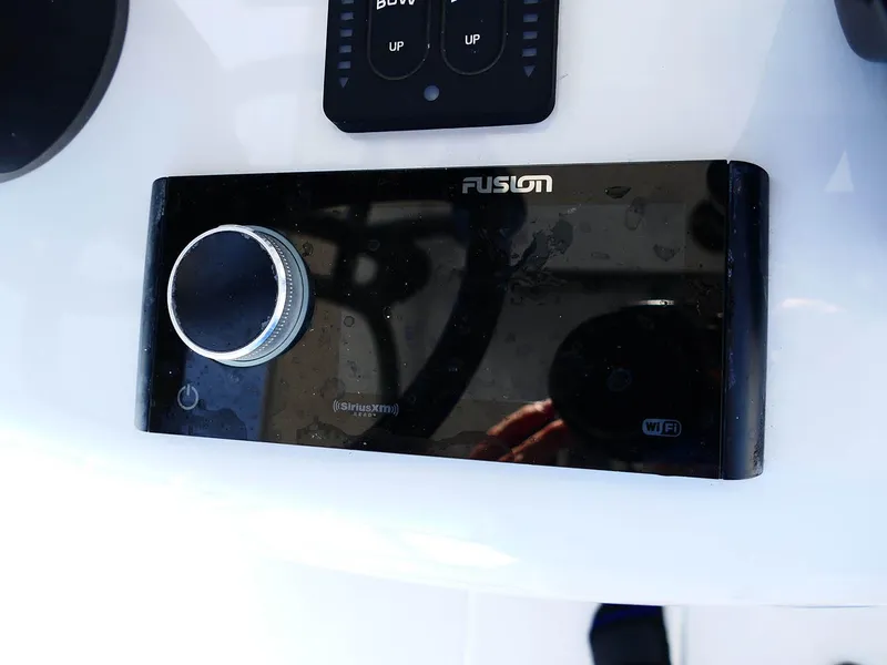 Slide: The Image of Fusion audio control panel on 2022 Contender 25 Bay boat dashboard. - 13