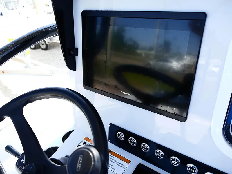 Slide: The Image of 2022 Contender 25 Bay boat dashboard with Garmin display and steering wheel. - 15