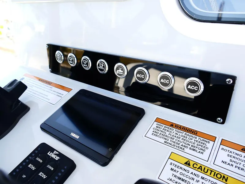 Slide: The Image of Control panel of 2022 Contender 25 Bay boat with labeled switches and Yamaha display. - 16