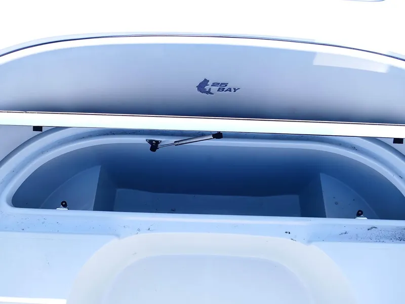 Slide: The Image of 2022 Contender 25 Bay boat storage compartment, open lid, interior view. - 21