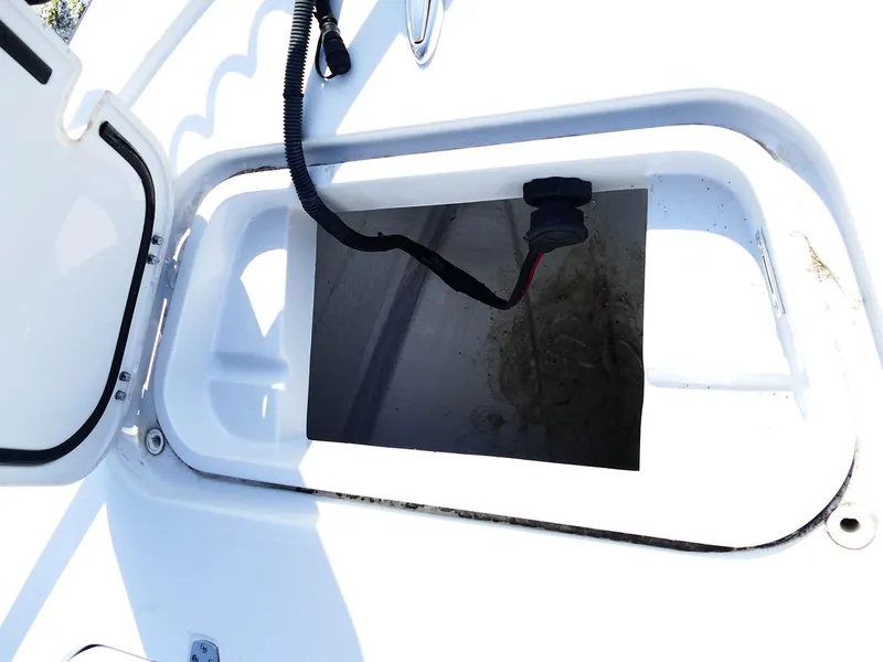 Slide: The Image of Open storage compartment on a 2022 Contender 25 Bay boat. - 24