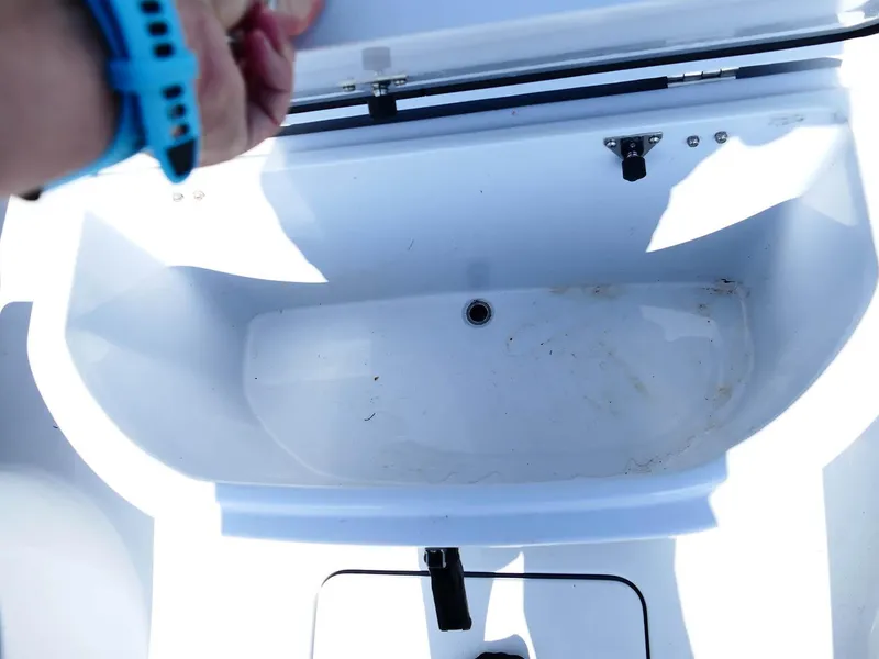 Slide: The Image of Open storage compartment on 2022 Contender 25 Bay boat. - 28