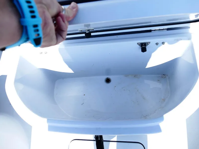 Slide: The Image of Open storage compartment on 2022 Contender 25 Bay boat. - 29