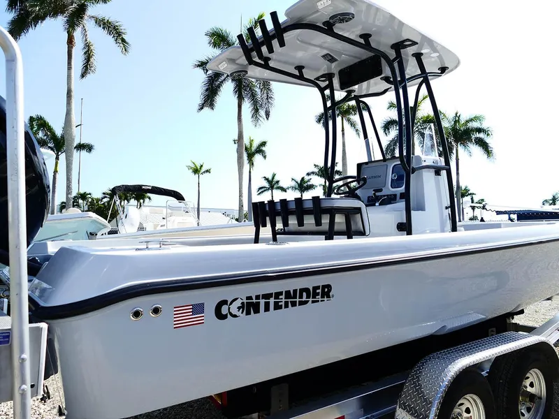 Slide: The Image of 2022 Contender 25 Bay boat on trailer, palm trees in background, sunny day. - 3