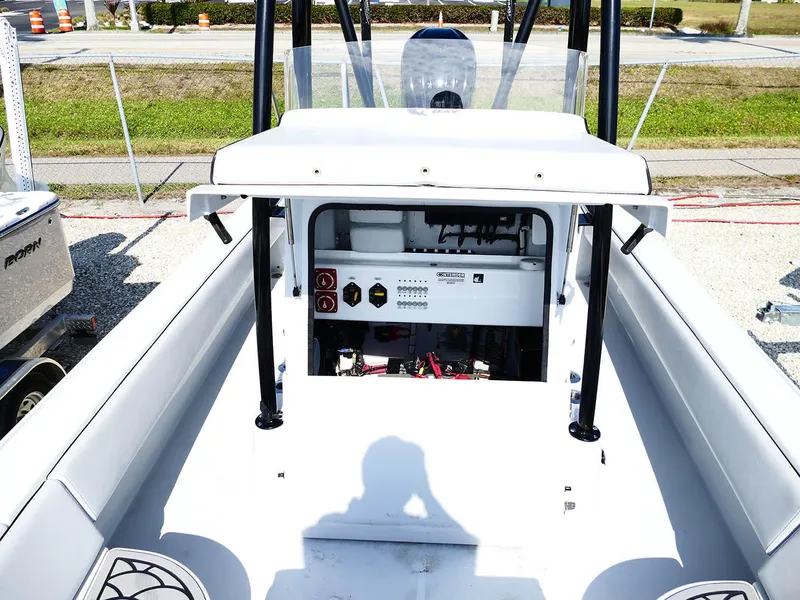 Slide: The Image of 2022 Contender 25 Bay boat interior with control panel and seating area. - 30