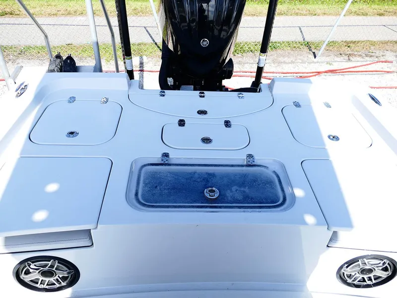 Slide: The Image of 2022 Contender 25 Bay boat deck with storage compartments and motor. - 36