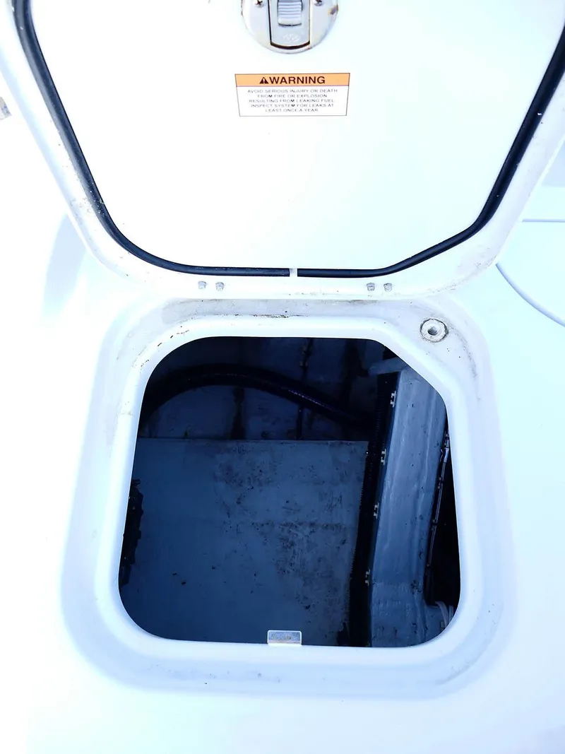 Slide: The Image of 2022 Contender 25 Bay boat hatch, open, showing interior compartment. - 40