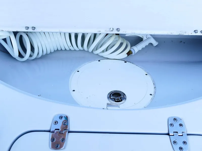 Slide: The Image of Storage compartment with coiled hose on 2022 Contender 25 Bay boat. - 41