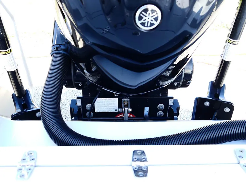 Slide: The Image of 2022 Contender 25 Bay boat engine close-up with Yamaha motor and hydraulic components. - 42