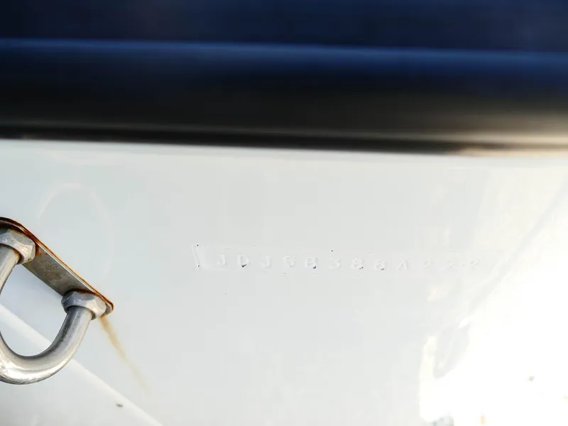 Slide: The Image of Close-up of a 2022 Contender 25 Bay boat hull with metal fitting. - 43