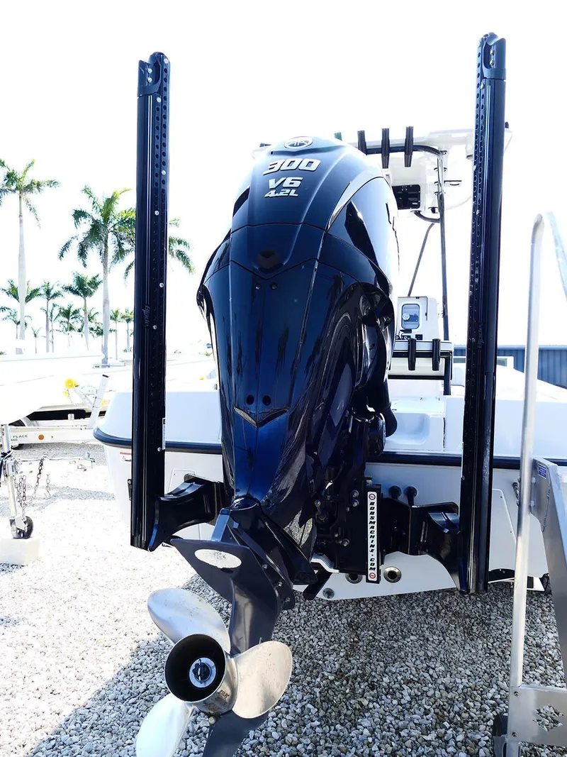 Slide: The Image of 2022 Contender 25 Bay boat with powerful outboard motor, displayed outdoors. - 5