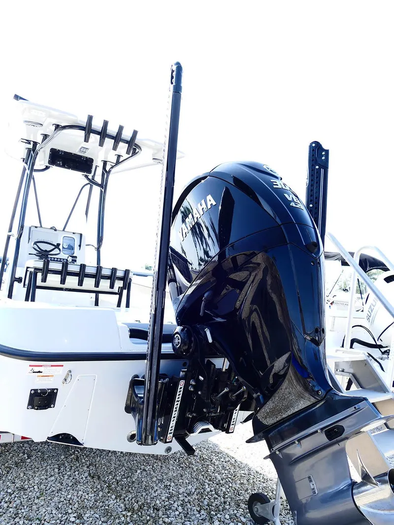 Slide: The Image of 2022 Contender 25 Bay boat with Yamaha outboard motor, displayed on gravel. - 6