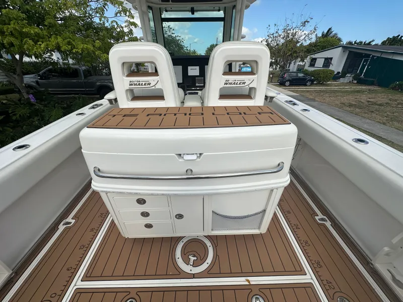 Slide: The Image of 2013 Boston Whaler 320 Outrage boat interior with seating and storage compartments. - 12