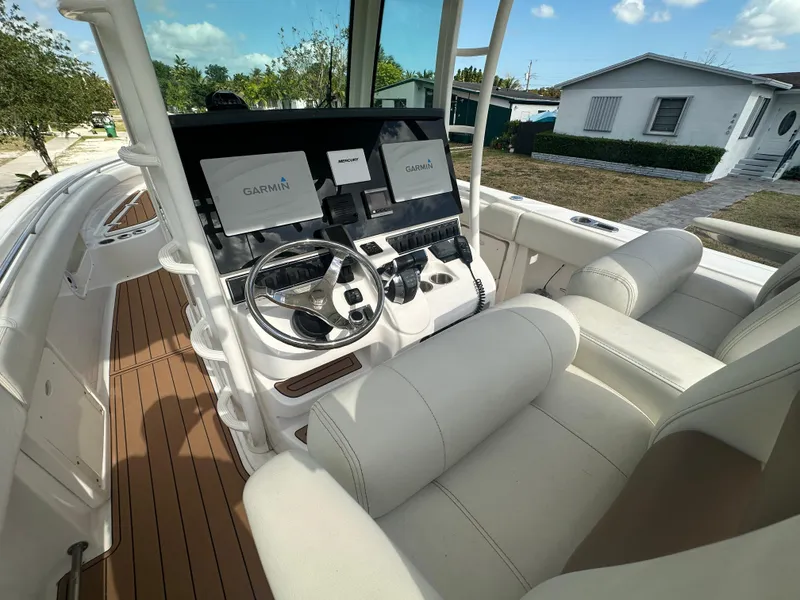 Slide: The Image of 2013 Boston Whaler 320 Outrage helm with Garmin displays and luxurious seating. - 14