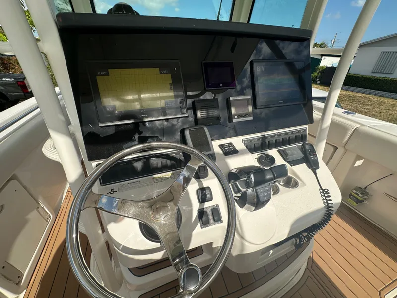 Slide: The Image of 2013 Boston Whaler 320 Outrage helm with navigation screens and controls. - 17