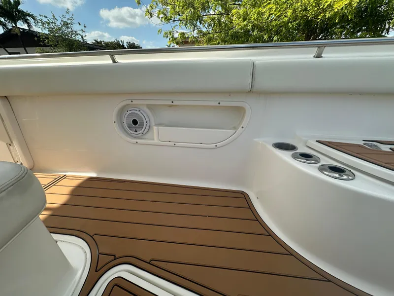 Slide: The Image of 2013 Boston Whaler 320 Outrage interior with teak flooring and speaker detail. - 22