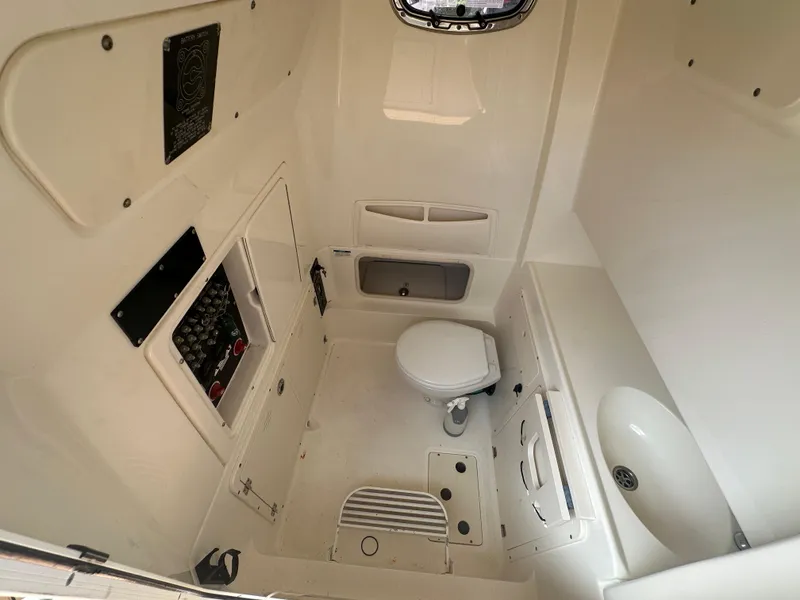 Slide: The Image of Interior of 2013 Boston Whaler 320 Outrage boat featuring a compact bathroom. - 23