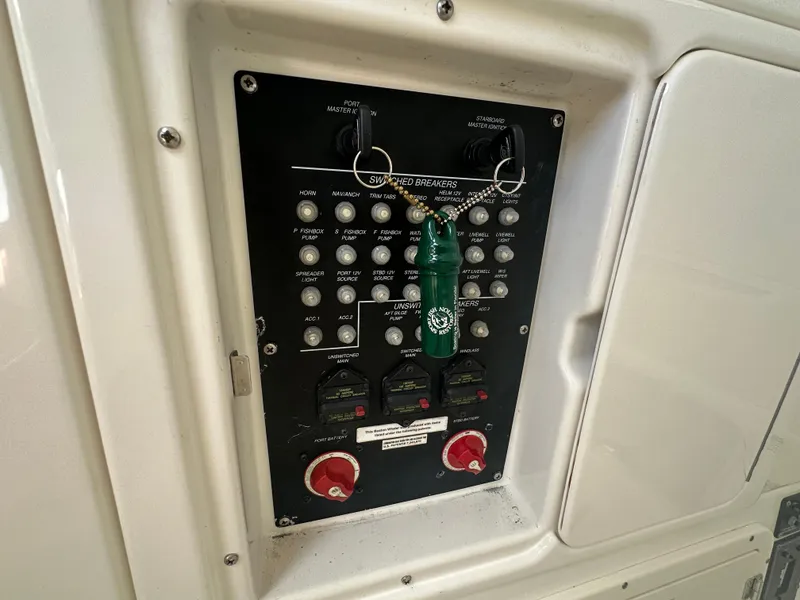 Slide: The Image of Control panel of a 2013 Boston Whaler 320 Outrage boat with switches and breakers. - 24