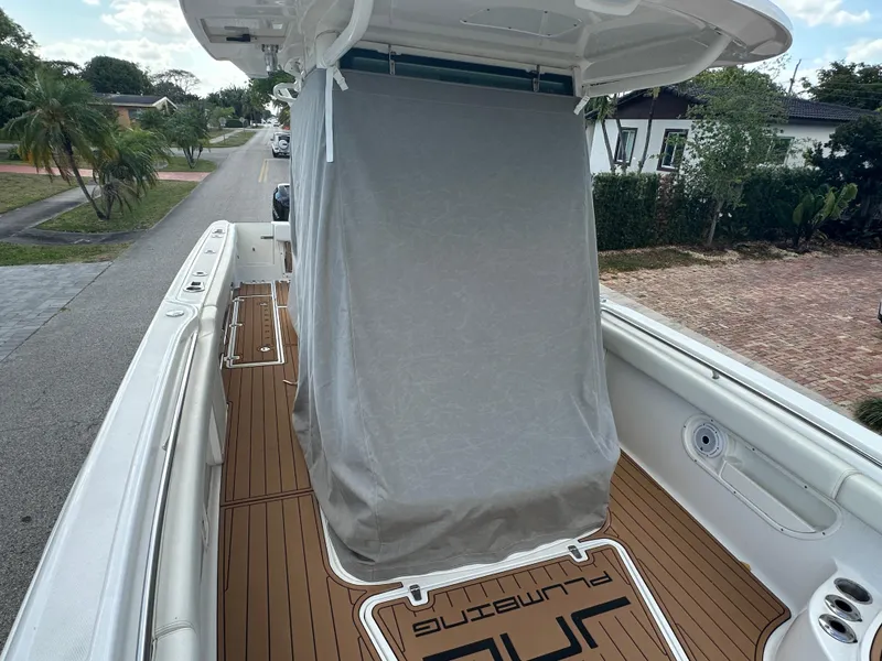Slide: The Image of 2013 Boston Whaler 320 Outrage boat with covered console, docked in a residential area. - 32