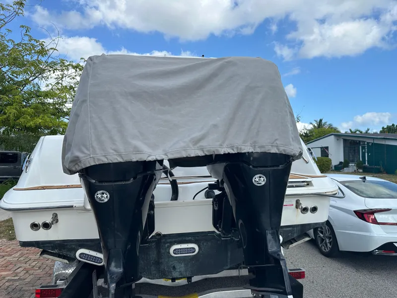 Slide: The Image of 2013 Boston Whaler 320 Outrage boat with covered engines, parked outdoors. - 33