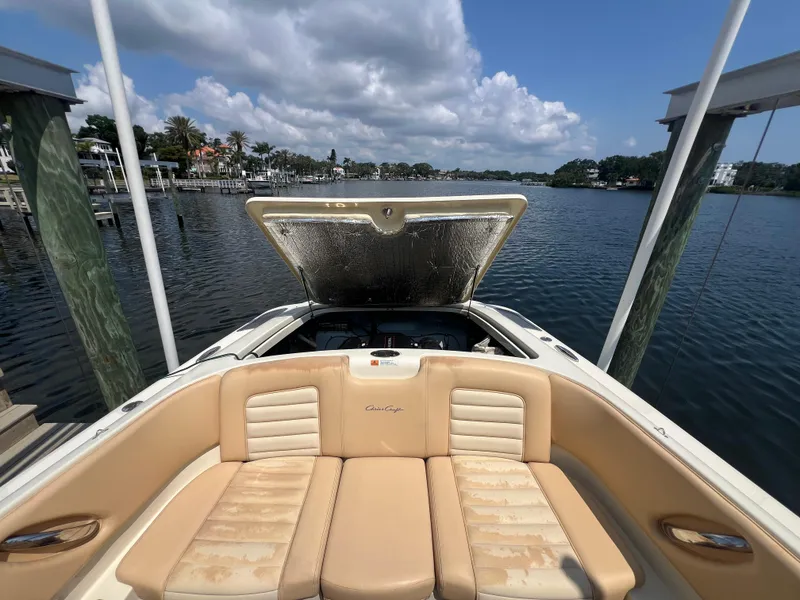 Slide: The Image of 2013 Chris-Craft Launch 22 boat with open engine cover, docked on a sunny day. - 14