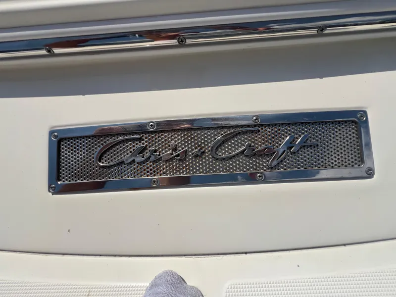Slide: The Image of 2013 Chris-Craft Launch 22 boat emblem on white surface. - 19