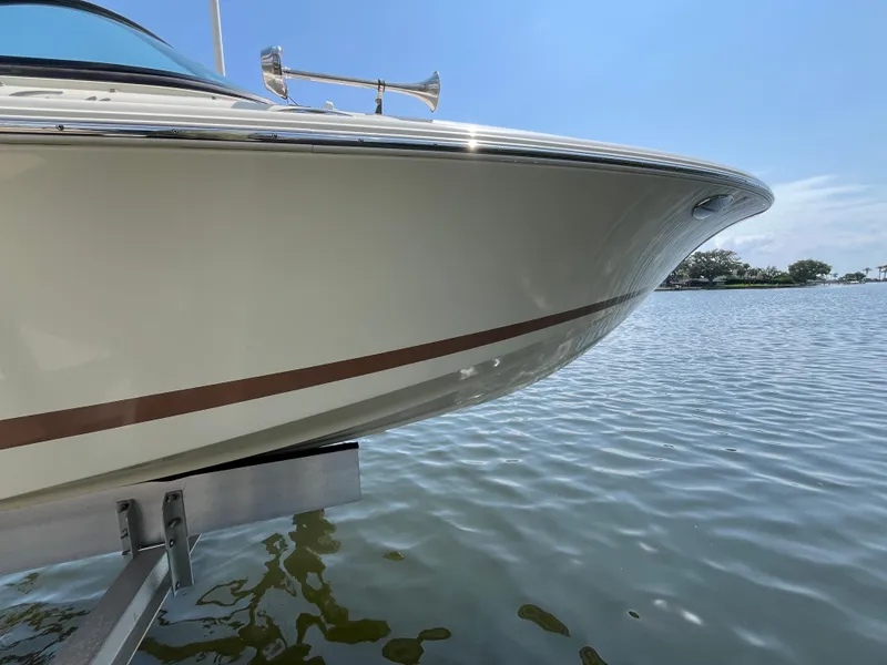 Slide: The Image of 2013 Chris-Craft Launch 22 boat on water, showcasing sleek design and elegant craftsmanship. - 23