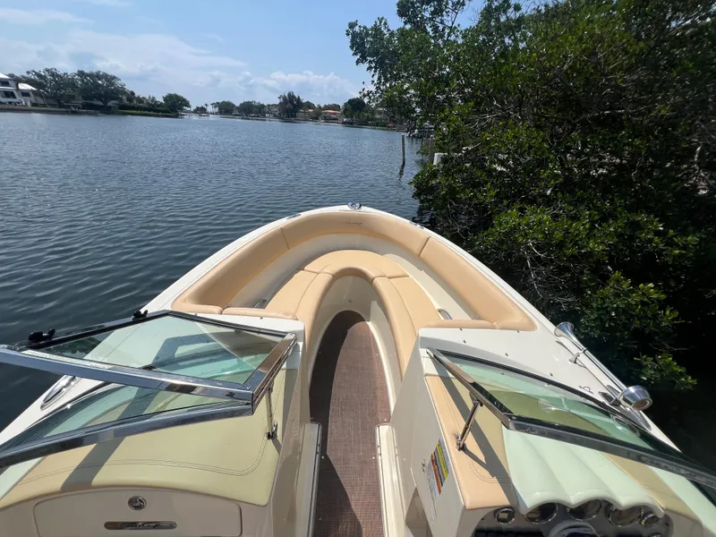 Slide: The Image of 2013 Chris-Craft Launch 22 boat on a serene lake with lush greenery. - 9