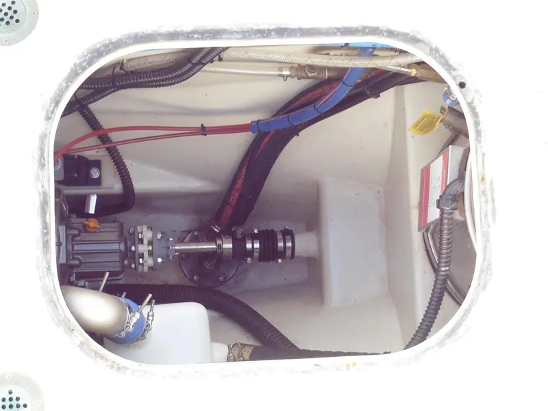 Slide: The Image of Engine compartment of a 2011 Cape George Cutter sailboat, showing mechanical components and wiring. - 10