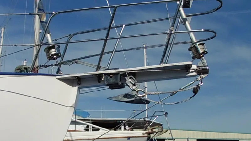 Slide: The Image of Cape George Cutter 2011 sailboat bow with anchor and railing against blue sky. - 12