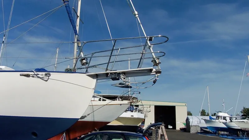 Slide: The Image of Cape George Cutter 2011 sailboat in a marina, clear sky background. - 13