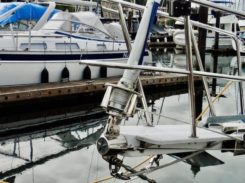 Slide: The Image of Cape George Cutter 2011 sailboat docked in marina, featuring detailed rigging and calm water reflections. - 15