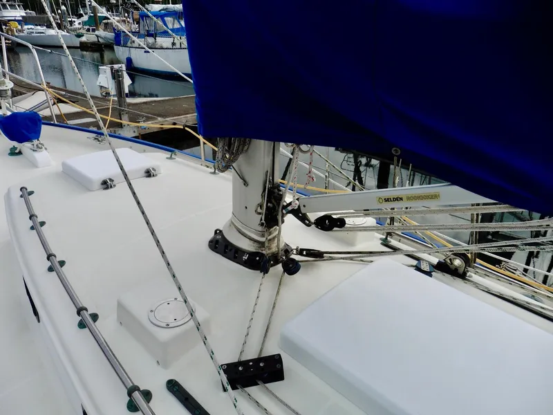 Slide: The Image of Cape George Cutter 2011 sailboat deck with blue sail cover in marina. - 17