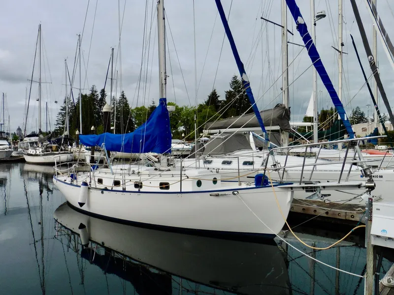 Slide: The Image of Cape George Cutter 2011 sailboat docked in a marina, surrounded by other boats. - 2