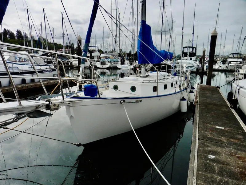 Slide: The Image of Cape George Cutter 2011 sailboat docked in a marina, surrounded by other boats. - 20