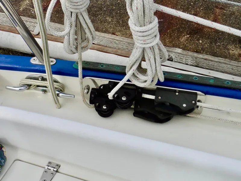 Slide: The Image of Cape George Cutter 2011 sailboat rigging and cleat detail with ropes and pulleys. - 23