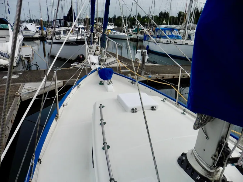 Slide: The Image of 2011 Cape George Cutter sailboat docked at a marina, surrounded by other boats. - 24