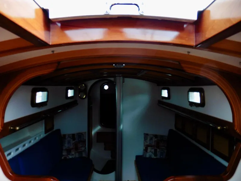 Slide: The Image of Interior of 2011 Cape George Cutter sailboat with wooden finish and cozy seating. - 26
