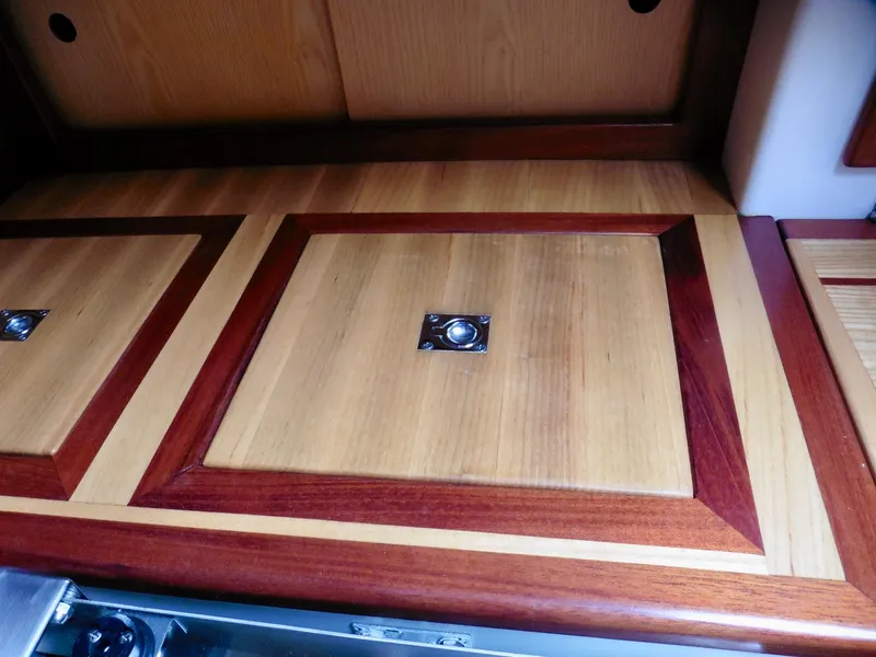 Slide: The Image of Wooden interior detail of a 2011 Cape George Cutter sailboat, featuring polished cabinetry. - 34