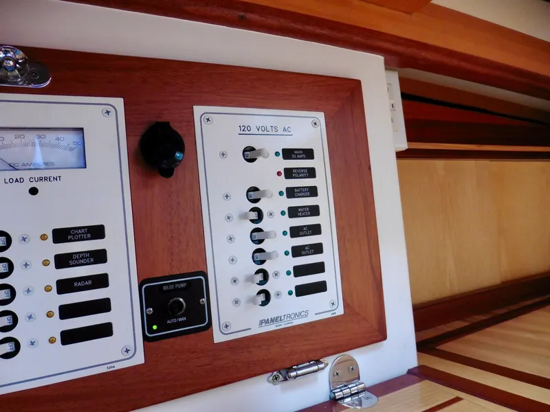 Slide: The Image of Electrical panel on a 2011 Cape George Cutter sailboat, featuring 120 volts AC controls. - 39