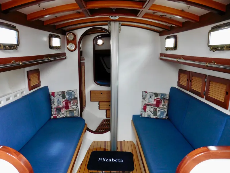 Slide: The Image of Interior of 2011 Cape George Cutter sailboat with blue seating and wooden accents. - 45